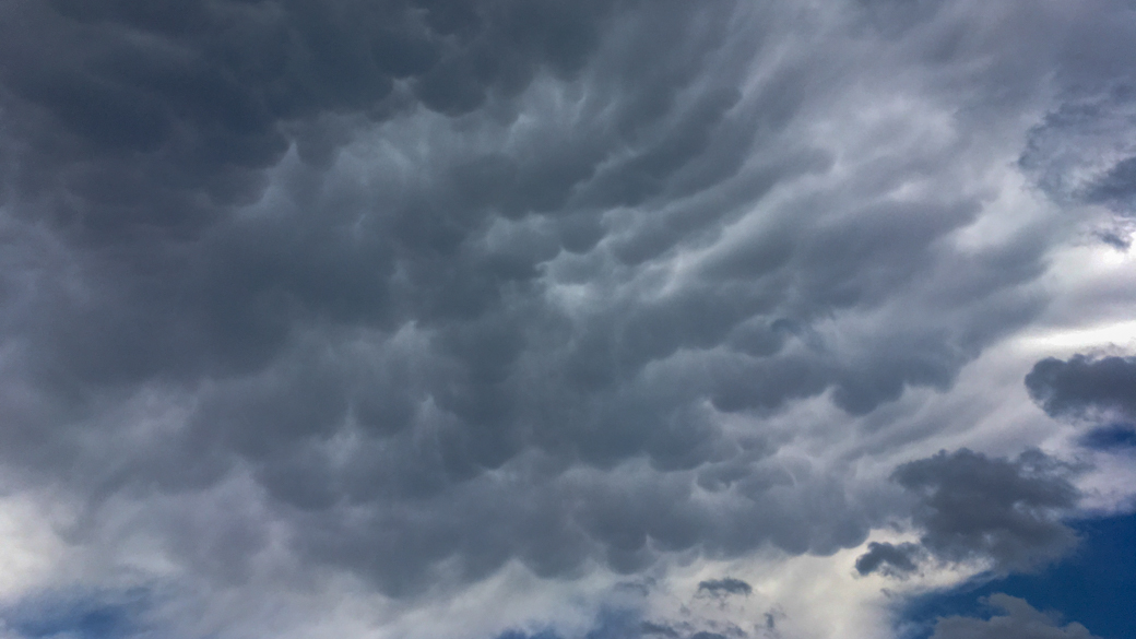 A photograph of cumulonimbus incus mamma clouds (Cb inc mam) in an unstable atmosphere